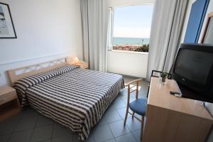Postel nebo postele na pokoji v ubytování HG Hotel Il Settebello