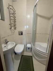 a bathroom with a sink and a toilet and a shower at Hotel palas tatariv in Tatariv +16 photos