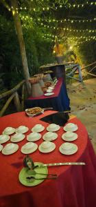 a red table with white plates and utensils on it at Lukenya Motorcross in Machakos