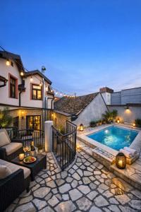 a backyard with a swimming pool and a house at IMAGINATOR RESIDENCE-Pool is extra pay- Parking 2 free space in Novi Sad