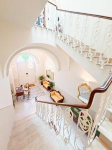 a staircase in a house with a living room at Palazzo Veneziani - Luxury Living in Monopoli in Monopoli +140 photos