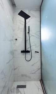 a shower in a bathroom with white marble at Executive Cozy Suite at THE HIDDEN DOMUS I Wenchi Suite in Accra +11 photos