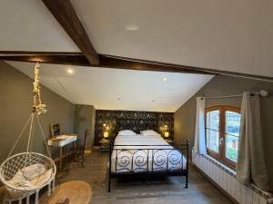 a bedroom with a bed and a swing at La Maison cachée du PAVILLON BELLEVUE in Belley