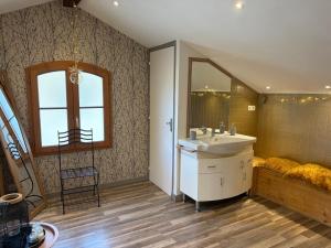 a bathroom with a sink and a mirror at La Maison cachée du PAVILLON BELLEVUE in Belley +19 photos