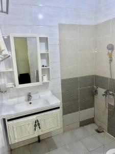 a bathroom with a sink and a shower at Amsy hotel in Dakar