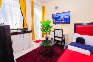 a bedroom with a bed and a table and a sink at The Haven in Nyeri