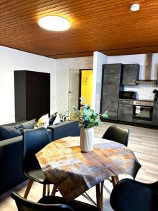 a living room with a table and a couch at Bad Rothenfelde Residence in Bad Rothenfelde +13 photos