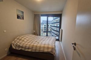 a bedroom with a bed and a window with a balcony at Christel Residence in Ostend +38 photos