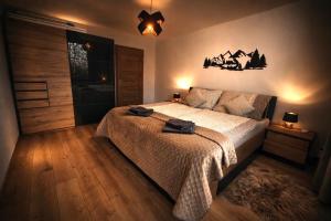 a bedroom with a bed in a room with a window at Hagy Apartments in Vysoké Tatry