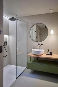 a bathroom with a sink and a mirror at Eagle & Marmot, Carezza Dolomites in Carezza al Lago +25 photos