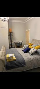 a bedroom with a bed with pillows and a table at Cambridge Villa St Annes in Lytham St Annes