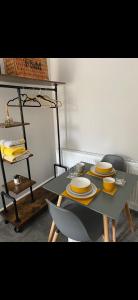 a table with yellow plates on it in a room at Cambridge Villa St Annes in Lytham St Annes