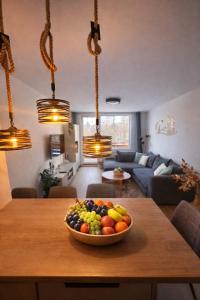 a bowl of fruit on a table in a living room at Hagy Apartments in Vysoké Tatry