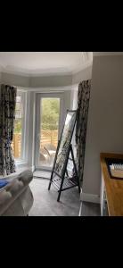 a room with a easel in a room with a window at Cambridge Villa St Annes in Lytham St Annes +4 photos