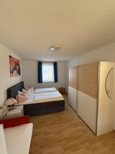 a bedroom with a large bed and a couch at Ferienwohnung Pipflhof in Wattens