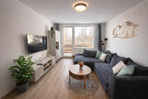 a living room with a couch and a table at Hagy Apartments in Vysoké Tatry
