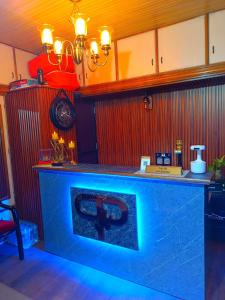 a bar with a blue counter top in a room at Peaks n Pines in Nainital