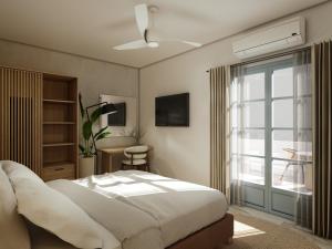 a bedroom with a large bed and a window at Inoe Boutique Hotel in Kamari