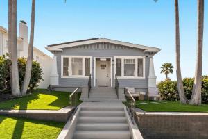 a white house with palm trees in front of it at Cliff View - Prime Downtown La Jolla in San Diego
