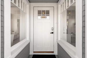a white door in a hallway with a bathroom at Cliff View - Prime Downtown La Jolla in San Diego