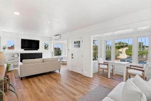 a living room with a couch and a fireplace at Cliff View - Prime Downtown La Jolla in San Diego +33 photos