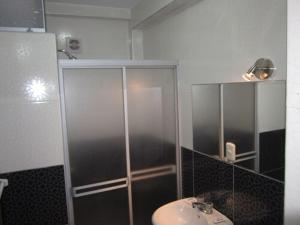 a bathroom with a sink and a glass shower at Hotel Plaza Bolognesi 344 in Trujillo