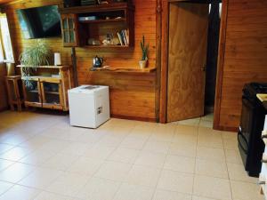a kitchen with a small refrigerator in a room at Cabaña azul in Los Antiguos