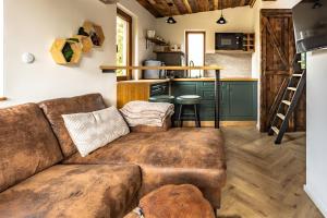 a living room with a couch and a kitchen at Buda 2 in Komjatná