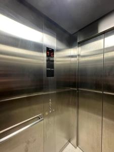 a elevator in a building with a metal wall at RV3 Prime Suites & Apartelle in Angeles
