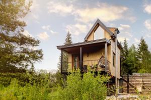 a house in the woods with a porch at Buda 2 in Komjatná