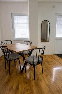 a wooden table with two chairs and a mirror at The Corner House in Delčevo