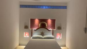 a bedroom with a bed with a head board at Beach Village Rest in Tarrafal