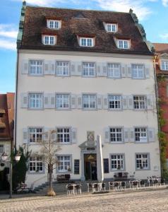 a large white building with tables in front of it at FeWo Seliger am Schloßplatz in Meersburg