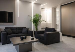 a living room with two couches and a table at Golden Island Resorts in Athens