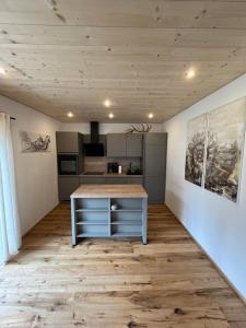 a kitchen with a island in the middle of a room at Saalach Chalet in Lofer +20 photos