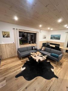 a living room with a couch and a table at Saalach Chalet in Lofer