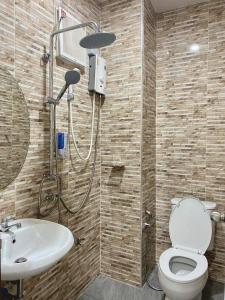a bathroom with a shower and a toilet and a sink at Neo cafe and hotel 2 in Sathani Maruan