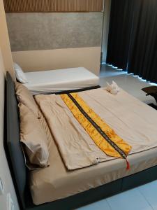 a bed in a room with two mattresses on it at Neo cafe and hotel 2 in Sathani Maruan
