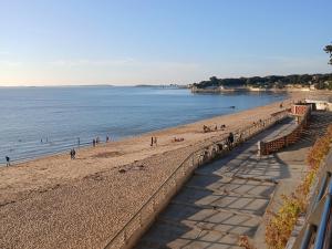 a group of people on a beach near the water at Grand Hôtel des Bains SPA in Fouras +67 photos