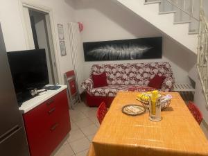 a living room with a table and a couch at Midnight sun pomposa lido in Lido di Pomposa