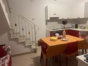 a small kitchen with a table and a staircase at Midnight sun pomposa lido in Lido di Pomposa
