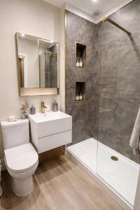 a bathroom with a toilet and a sink and a shower at Townhouse in Shaftesbury +20 photos