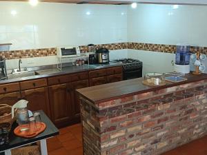 a kitchen with a brick counter top in a kitchen at Alta Vibracion Casa Boutique in Villa de Leyva