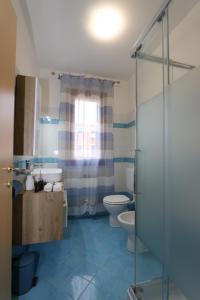 a bathroom with a toilet and a glass shower at Residence Sole&Mare in Rosapineta +11 photos