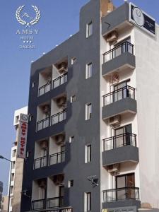 a building with a clock on the side of it at Amsy hotel in Dakar