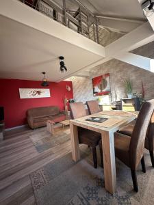 a living room with a wooden table and chairs at The2 Work or holiday apartment in Godshuis