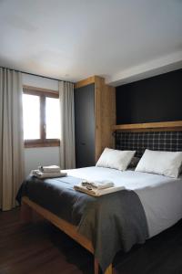 a bedroom with a large bed with two towels on it at Beautiful chalet with views in Montgenèvre