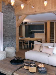 a living room with a couch and a table at Beautiful chalet with views in Montgenèvre