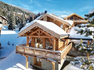 a log home in the snow with snow covered at Beautiful chalet with views in Montgenèvre