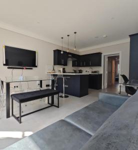 a kitchen with black cabinets and a tv on the wall at The Windsor Courtyard in Windsor